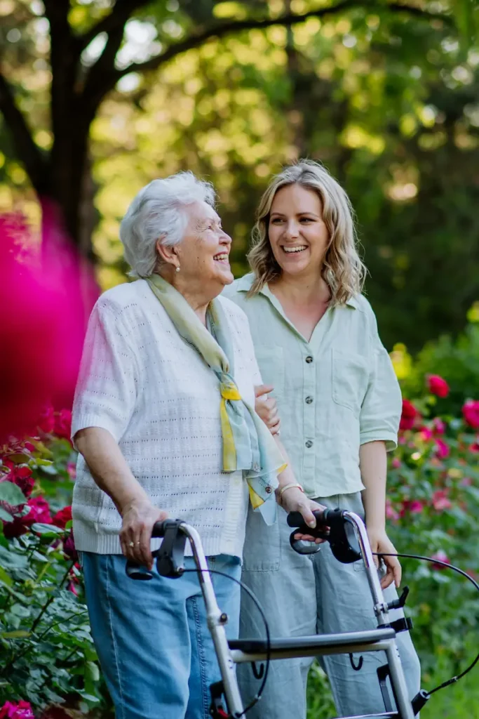 Elderly lady with carer in the park