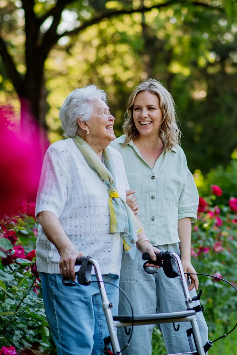 Elderly lady with carer in the park